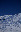 A snowy mountain landscape under a clear blue sky. A crescent moon is visible in the sky. blurred out low res